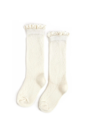 The Ivory Fancy Lace Top Knee High Socks by Ivy City Co feature a delicate lace ruffle trim, perfect for pairing with baby dresses. Cream-colored and stylish, they’re displayed on a white background.