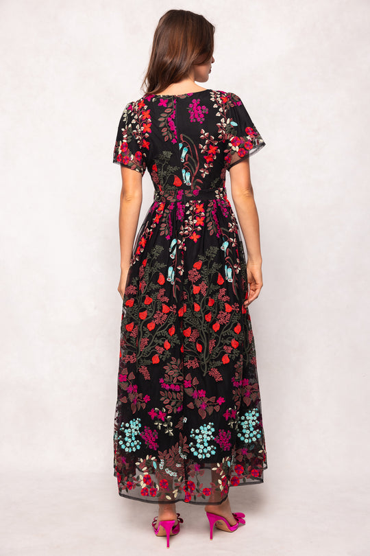 Woman wearing a floral dress with a white background