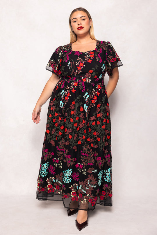 Woman wearing a floral dress with a white background