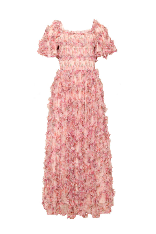 Womans pink floral dress against a white background