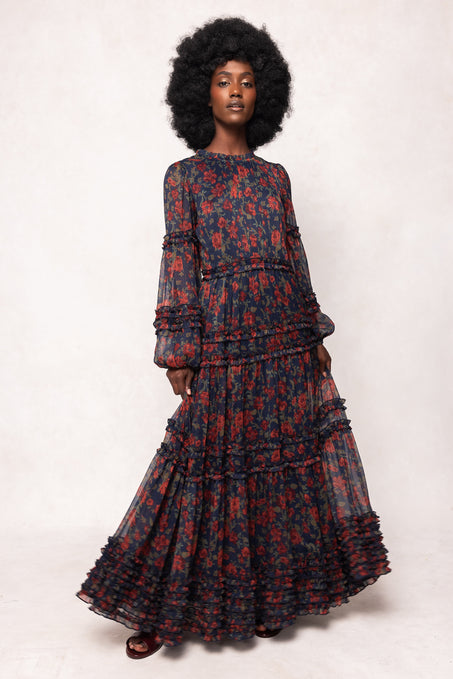Woman wearing a patterned dress on a white background