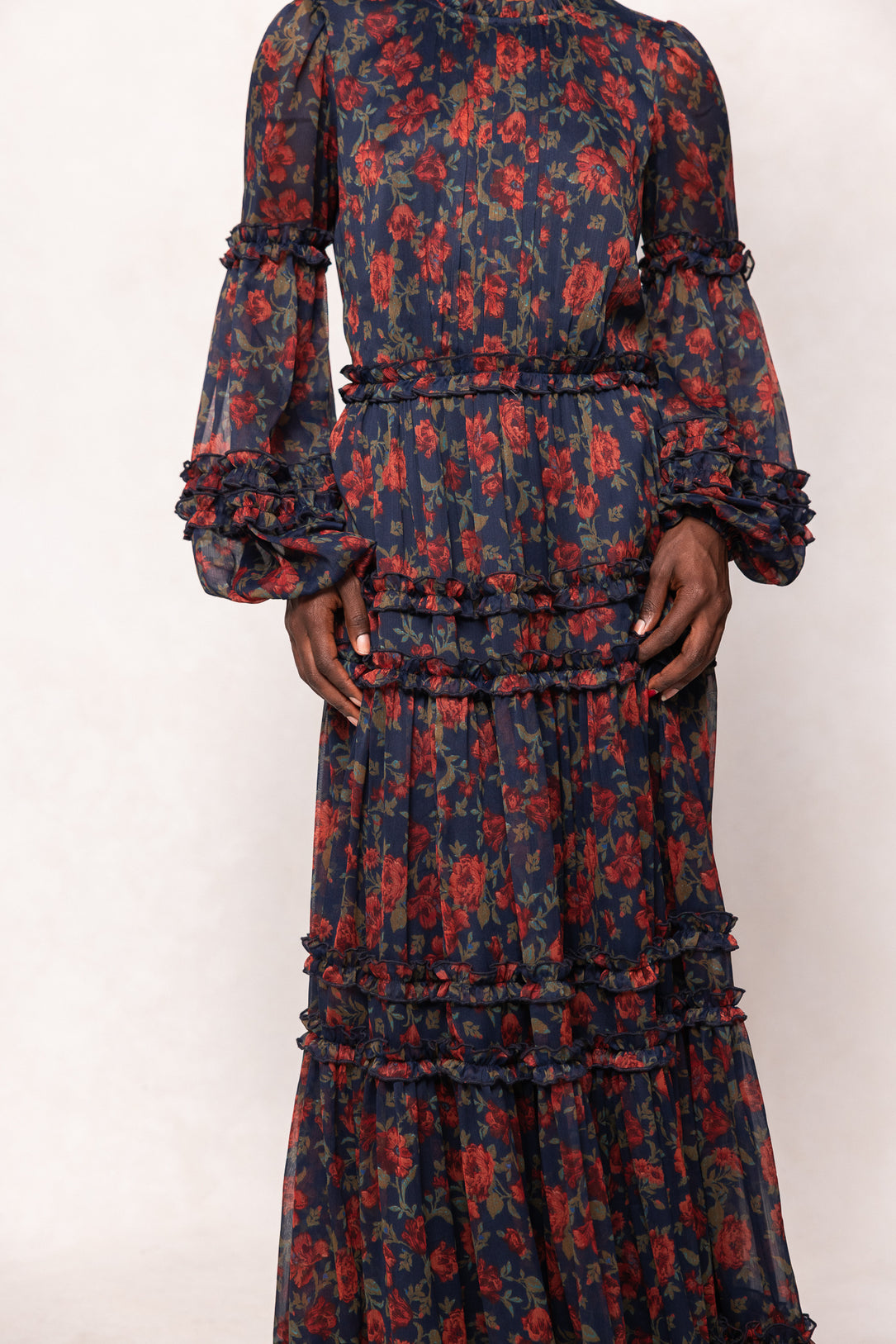 Long-sleeve dress with red floral pattern on a white background