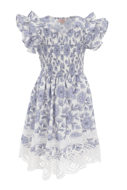The Mini Hattie Dress in Blue Floral by Ivy City Co features short ruffled sleeves, a shirred bodice, flared skirt, and lace cut-out hem—perfect for sunny days with its playful pattern and charming cotton style.