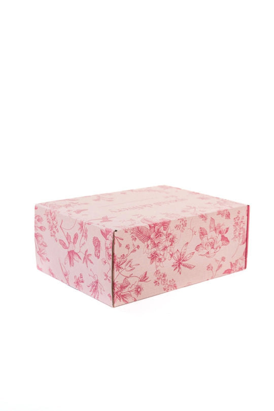 A closed rectangular Gift Box by Ivy City Co, featuring a pink floral pattern on all sides and displayed against a plain white background—ideal for use as a personalized gift box for any occasion.