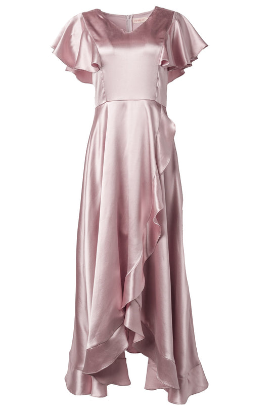 The Callie Dress in Blush Satin by Ivy City Co is an elegant V-neck maxi dress featuring shiny blush pink satin, flutter sleeves, and a ruffled high-low hem—displayed on a white background—making it the perfect graceful bridesmaid or bridal party dress.