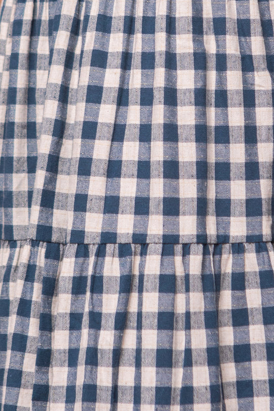 Close-up of the Hailey Dress in Indigo Gingham by Ivy City Co, featuring blue and white checkered gingham fabric with gathered seams and a soft texture—perfect as a maternity friendly dress.