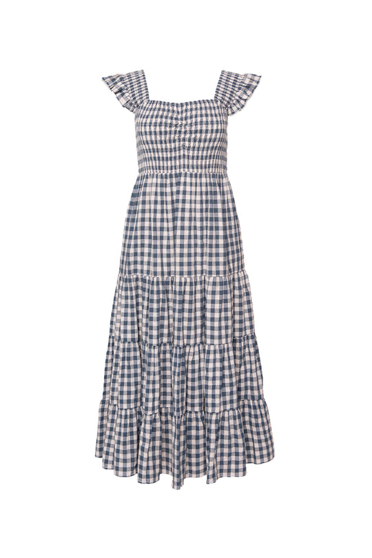 The Hailey Dress in Indigo Gingham by Ivy City Co features ruffled cap sleeves, a smocked bodice, tiered skirt, and is nursing friendly. Displayed on a white background.