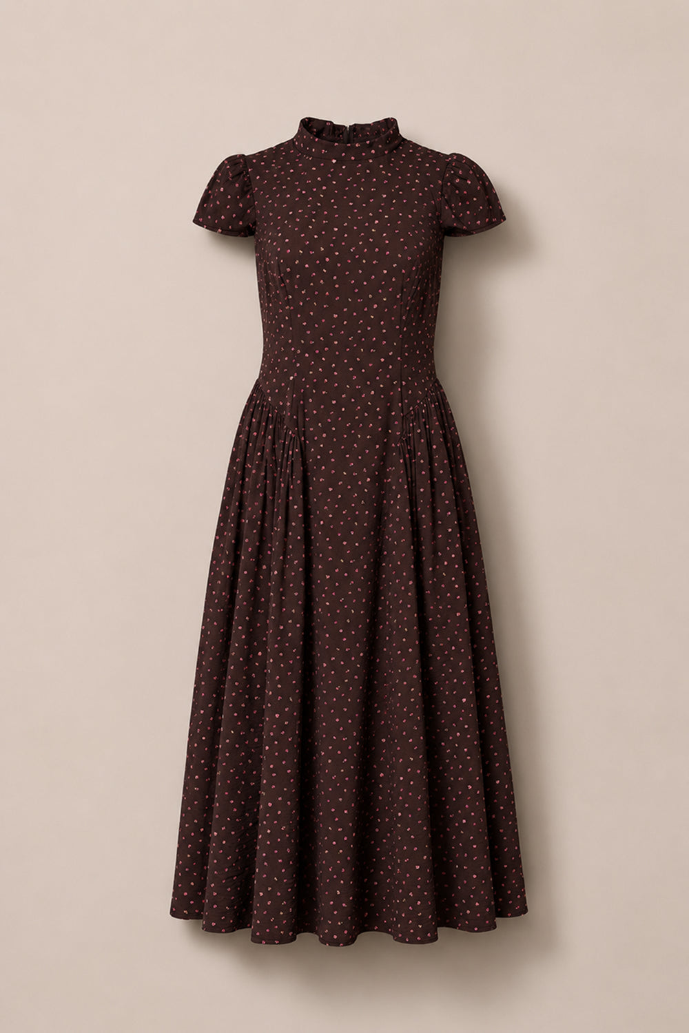 A chocolate brown, short-sleeved Harriet Dress in Dainty Roses by Ivy City Co, featuring a fitted bodice, high neckline, and a vintage-inspired midi silhouette with a gathered waist. The dress is adorned with delicate white dainty rose prints—making it a charming choice for a fall wedding.