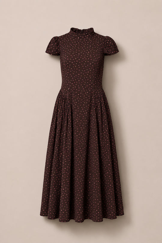 A chocolate brown, short-sleeved Harriet Dress in Dainty Roses by Ivy City Co, featuring a fitted bodice, high neckline, and a vintage-inspired midi silhouette with a gathered waist. The dress is adorned with delicate white dainty rose prints—making it a charming choice for a fall wedding.