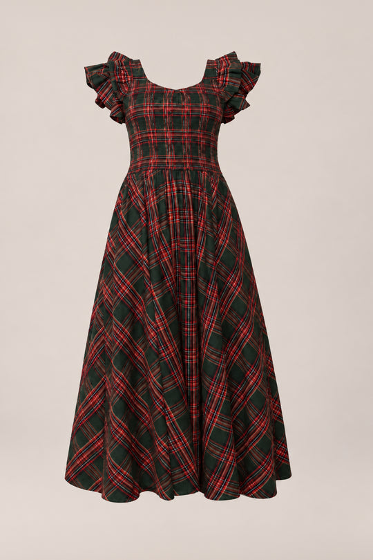 The Hattie Dress in Evergreen Plaid by Ivy City Co features a vintage-inspired red and green plaid pattern, short ruffled sleeves, a fitted bodice, and a flared ankle-length skirt. Maternity friendly and ideal as an enchanting holiday dress, it is displayed on a simple light background.