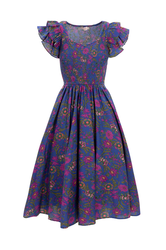 The Ivy City Co Hattie Dress in Blue Multicolor Floral is a maternity-friendly cotton midi with pink and green florals, a fitted smocked bodice, short ruffled sleeves, and a full skirt.