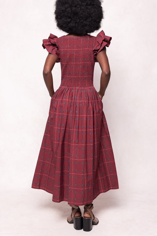 Red plaid dress worn by a person on a white background
