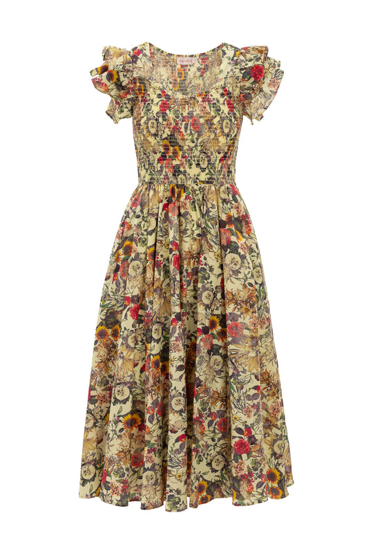 The Hattie Dress in Rose Vine by Ivy City Co is a knee-length, floral maternity-friendly dress with short ruffled sleeves, a fitted smocked bodice, and a flowing gathered skirt in red, yellow, and green.