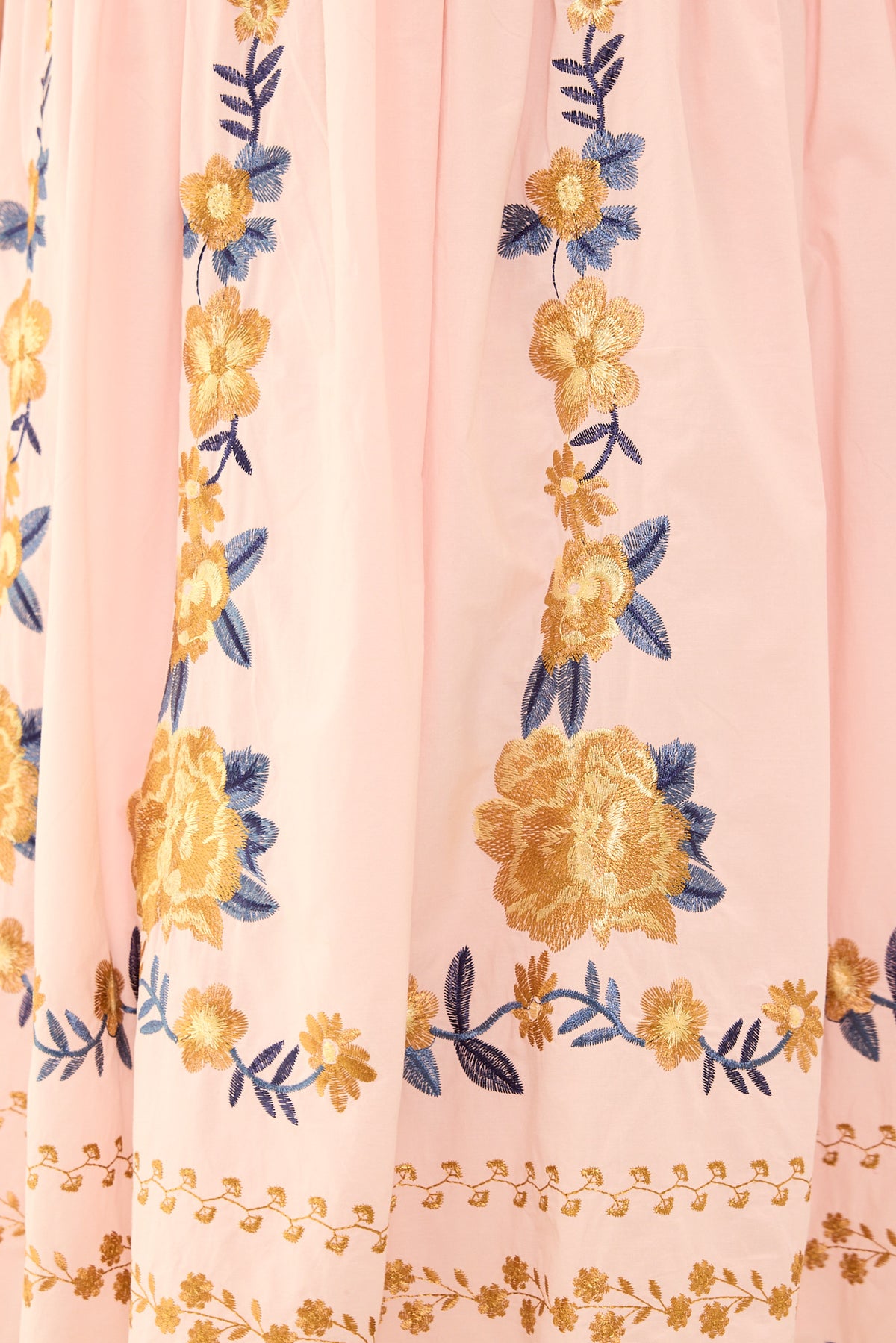 Floral embroidery on a pink fabric background