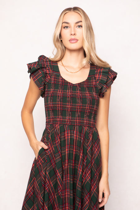 model in a evergreen plaid dress on a white back ground 