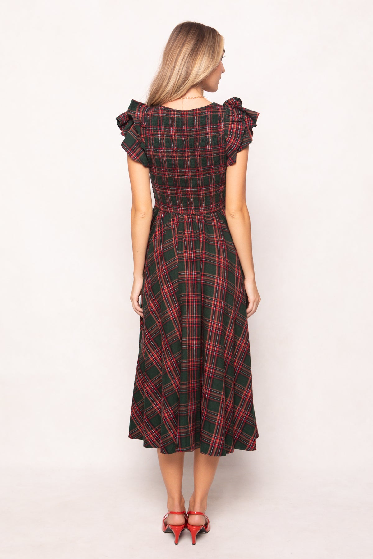 model in a evergreen plaid dress on a white back ground 
