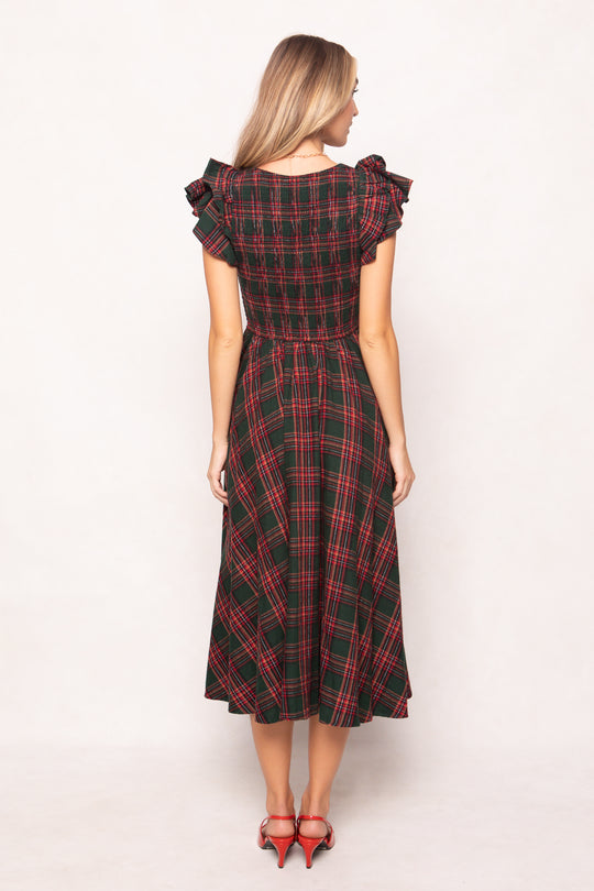 model in a evergreen plaid dress on a white back ground 
