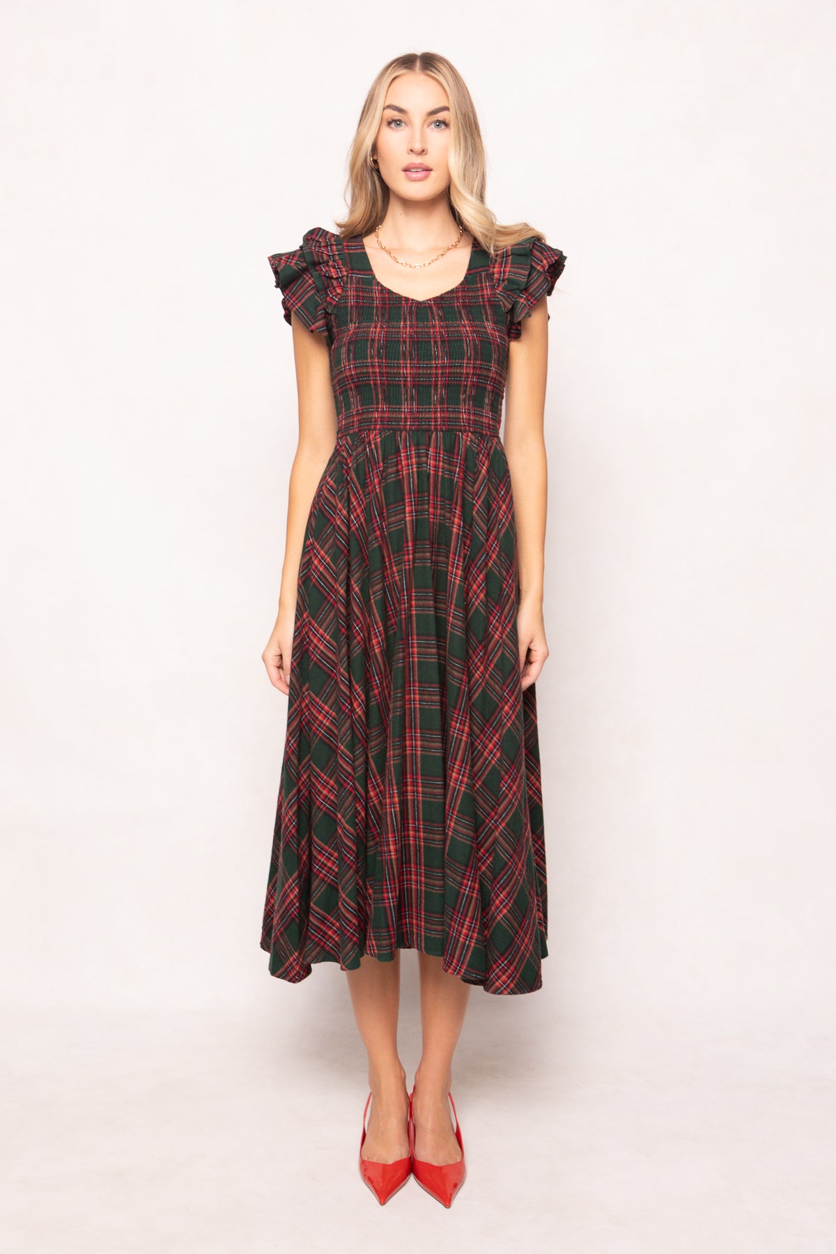 model in a evergreen plaid dress on a white back ground 