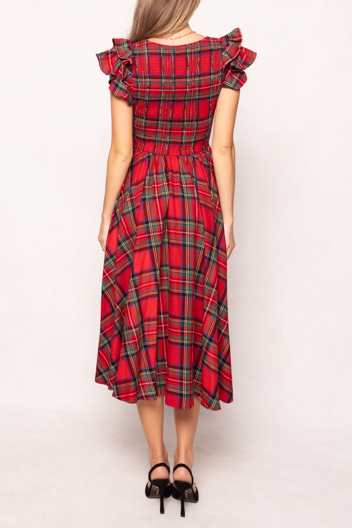 woman in red plaid dress on a white background