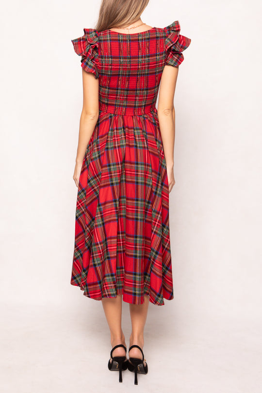woman in red plaid dress on a white background