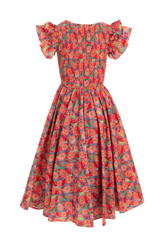 The Hattie Dress in Poppy by Ivy City Co features a vibrant cotton poppy print, short ruffled sleeves, a smocked bodice, and a full gathered skirt in cheerful red, pink, orange, and green floral tones.