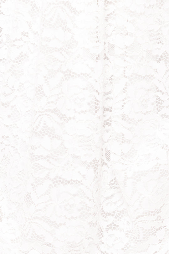 Close-up of the Hattie Dress in White Lace by Ivy City Co, showcasing its intricate floral lace—ideal for a romantic midi look or an elegant bridal shower.