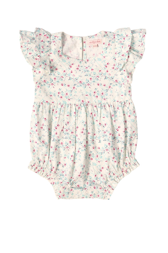 The Ivy City Co Baby Hattie Romper in Pansy Trellis features short ruffle sleeves, a gathered waist, pink and blue floral print, button back closure, and elastic leg openings—perfect for Easter or spring outings.