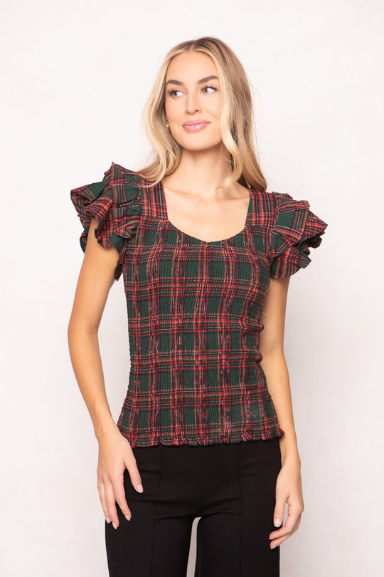 woman is wearing a evergreen plaid top on a white background