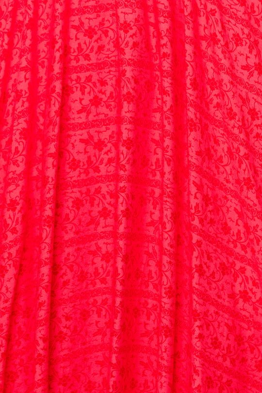 Bright red fabric with a subtle floral vine pattern and gentle vertical pleats—ideal for making the Hattie Dress in Crimson Pink by Ivy City Co or an elegant cotton midi dress.