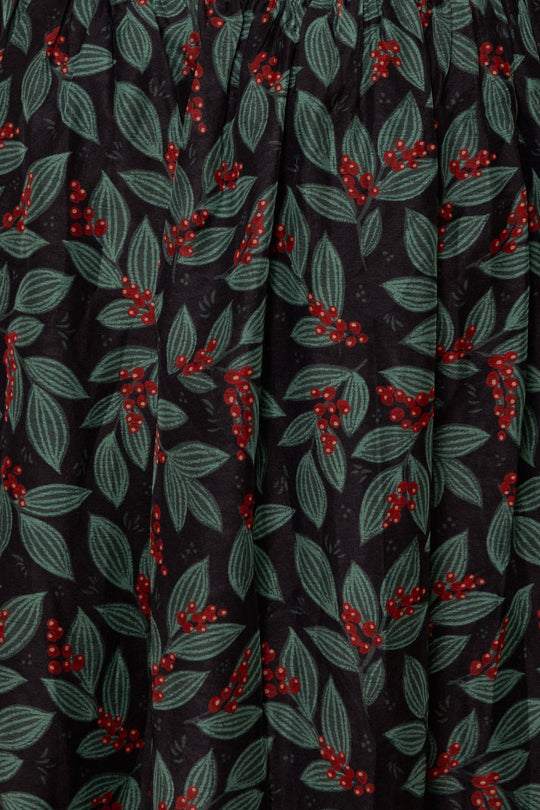 Ivy City Co Hayden Dress in Berries featuring a smocked bodice with clusters of red berries and green leaves on a dark background.
