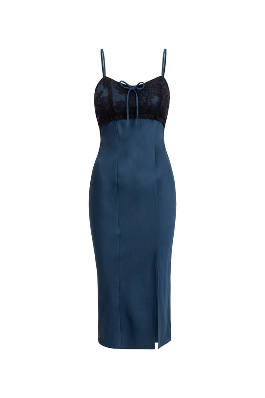 The Hayes Dress in Navy & Black by Ivy City Co features a blue midi-length silhouette with thin straps, a lace-trimmed black bodice, sweetheart neckline, front bow detail, and a front slit on the skirt. This elegant navy satin dress is displayed on a white background.