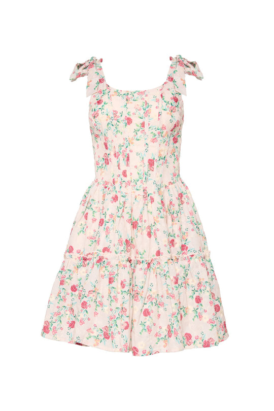 The Helene Dress in Vibrant Chintz by Ivy City Co features a sleeveless white design with a pink and green floral chintz print, ruffled shoulder straps, a fitted bodice, and a flared tiered skirt crafted from soft cotton eyelet.