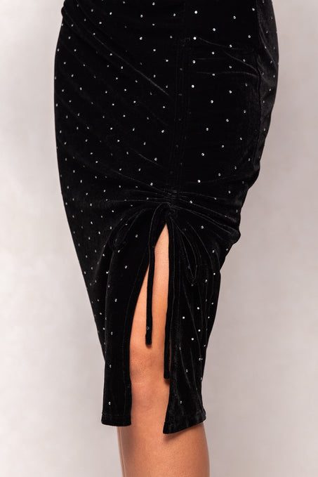 Black velvet skirt with silver studs and a front slit on a white background