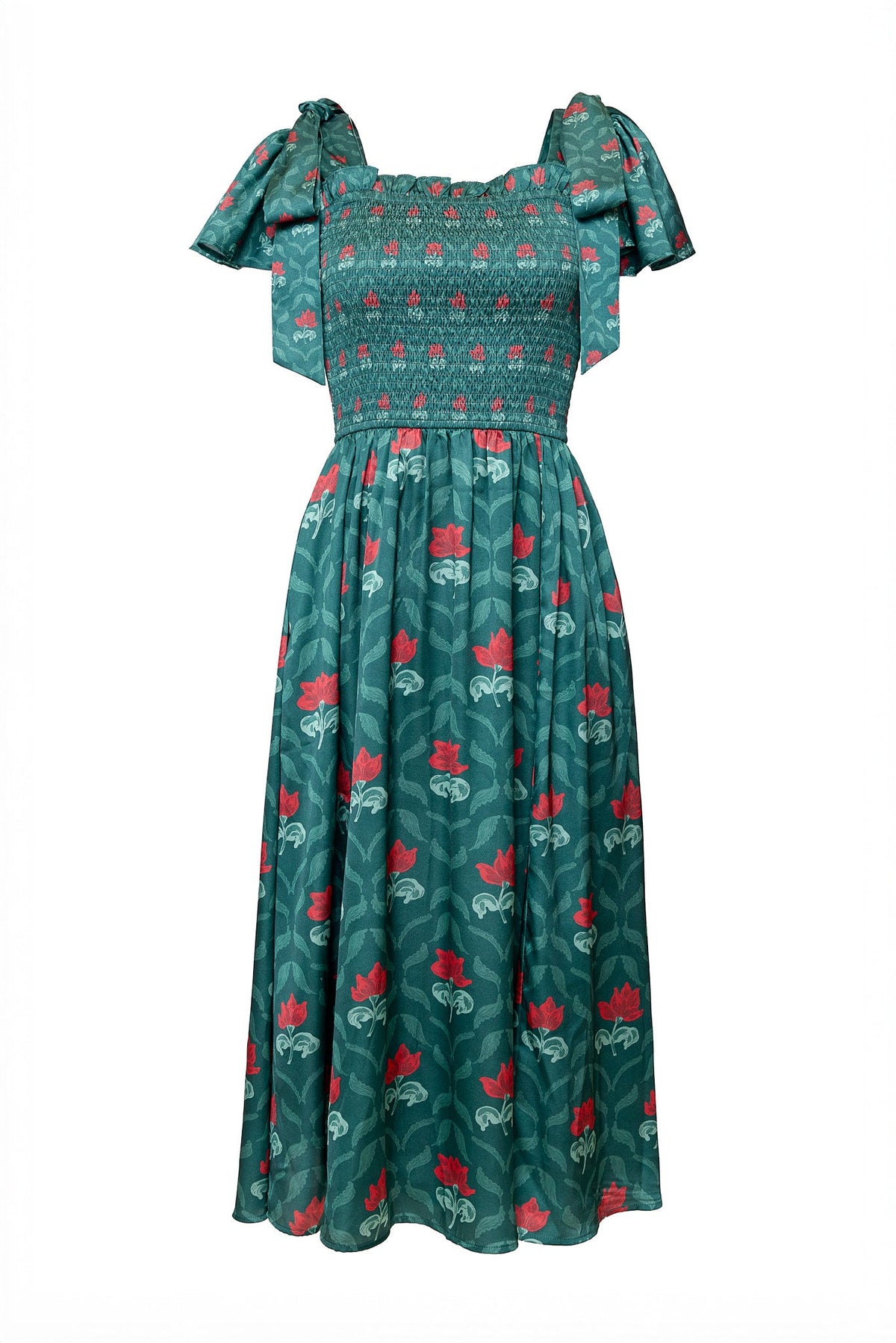The Rayna Dress in Green Floral Block by Ivy City Co features a smocked bodice, wide shoulder straps tied in bows, and a vibrant red floral print adorning both the top and skirt. Displayed against a white background, this teal green dress is designed to be both maternity friendly and nursing friendly, providing comfort and style through every stage.