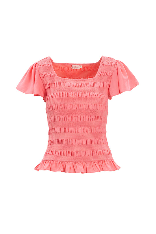 The Ivy City Co Janessa Top in Pink is a seersucker piece with a smocked bodice, square neckline, flutter sleeves, and ruffle peplum hem—shown on a white background.