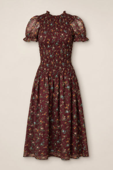 The Jennifer Dress in Aubergine Elysian Vine by Ivy City Co is a midi dress featuring a smocked bodice, puff sleeves with ruffle trim, and a flared skirt adorned with multicolor ditsy floral print on sheer fabric. Maternity friendly and effortlessly stylish, it provides both comfort and charm for any occasion.