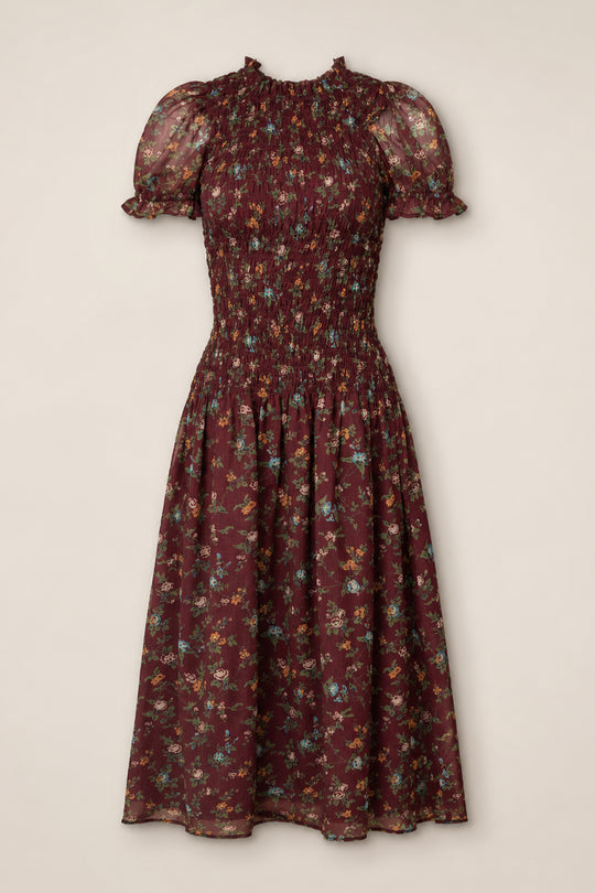The Jennifer Dress in Aubergine Elysian Vine by Ivy City Co is a midi dress featuring a smocked bodice, puff sleeves with ruffle trim, and a flared skirt adorned with multicolor ditsy floral print on sheer fabric. Maternity friendly and effortlessly stylish, it provides both comfort and charm for any occasion.
