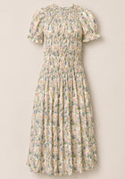 The Jennifer Dress in Autumn Bouquet by Ivy City Co is a light cream dress adorned with a floral print, featuring short puff sleeves, a smocked bodice for comfort, and a gathered midi-length skirt. Maternity friendly and effortlessly elegant, it’s showcased against a plain background.