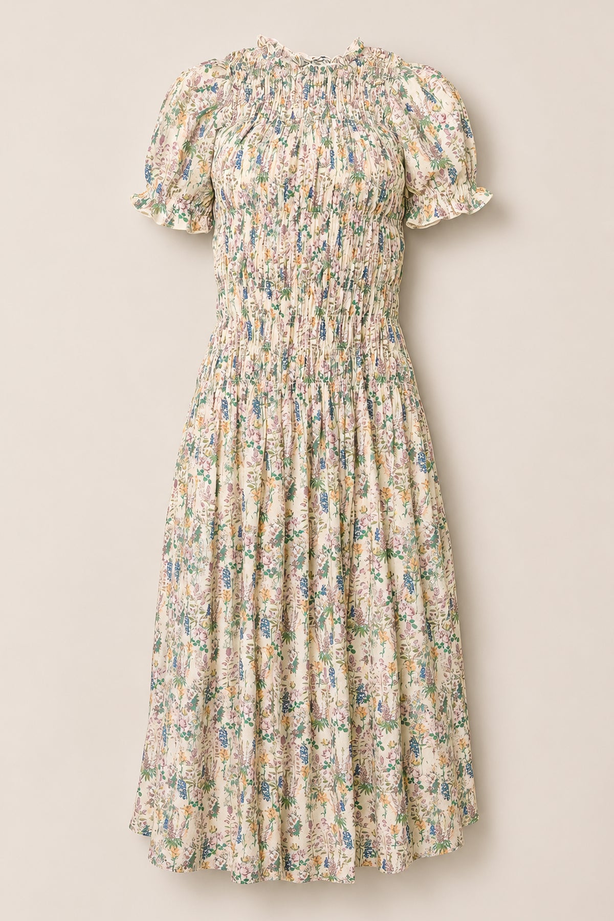 The Jennifer Dress in Autumn Bouquet by Ivy City Co is a light cream dress adorned with a floral print, featuring short puff sleeves, a smocked bodice for comfort, and a gathered midi-length skirt. Maternity friendly and effortlessly elegant, it’s showcased against a plain background.