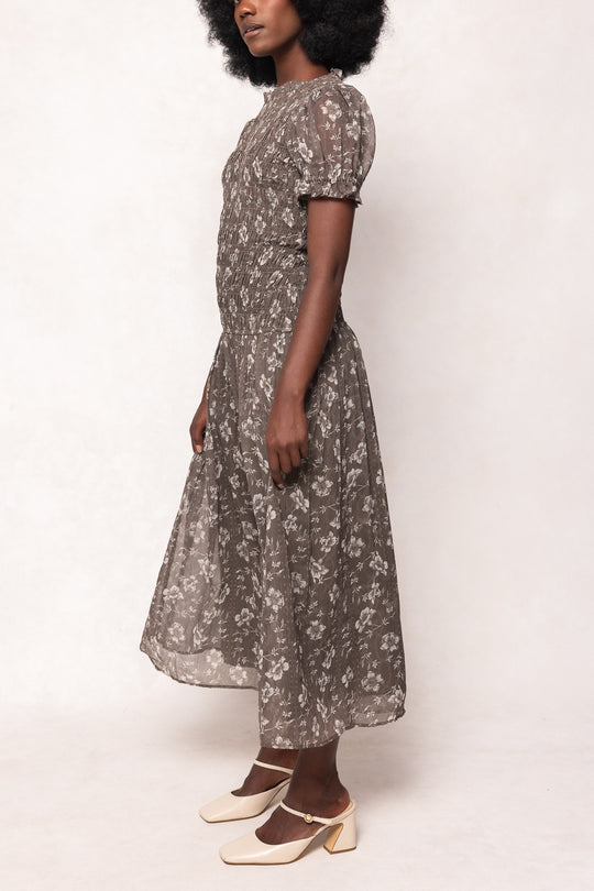 Woman wearing a floral dress on a white background