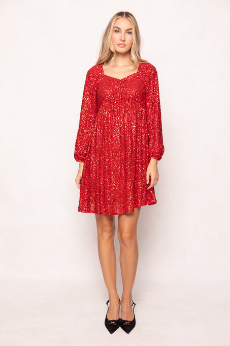 Woman wearing a red dress with long sleeves on a white background