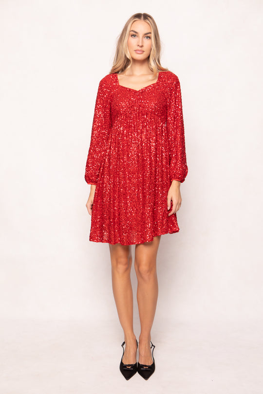 Woman wearing a red dress with long sleeves on a white background