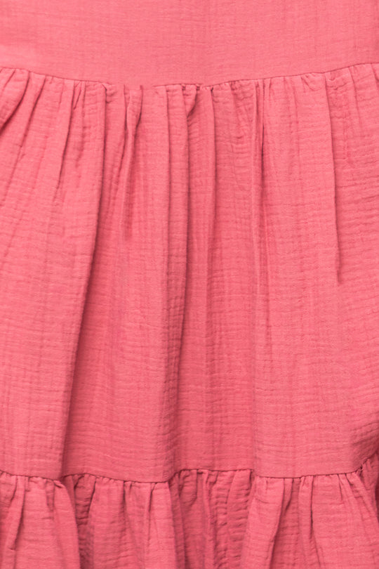 Close-up of the Jovie Dress in Pink by Ivy City Co, featuring soft, textured cotton gauze with gathered ruffled stitching for an elegant, flowing, and comfortable layered look.