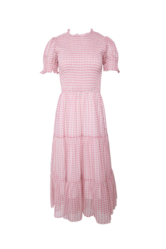 The Cordelia Dress in Desert Rose Gingham by Ivy City Co is a dusty pink gingham midi dress featuring puff short sleeves, a fitted smocked bodice, and a tiered skirt—beautifully designed to be maternity friendly.