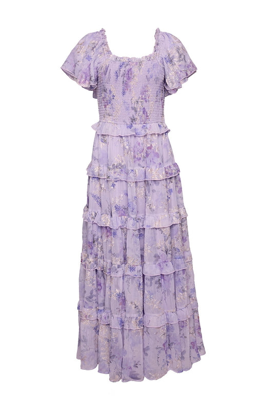 The Winnie Dress in Lavender Aquarelle Fleur by Ivy City Co features a delicate floral pattern, short puff sleeves, a smocked bodice, and a layered ruffle skirt. With its flowy, feminine silhouette and maternity-friendly design, this maxi dress is perfect for any special occasion.
