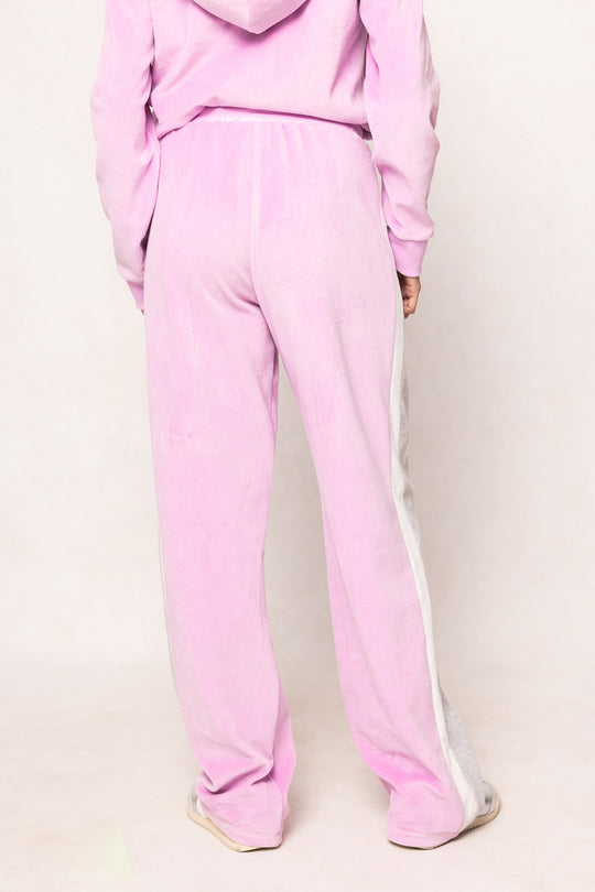 Woman in a pink sweatsuit against a white background