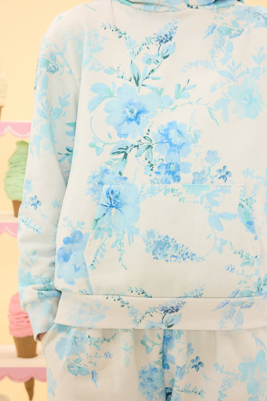 Floral patterned outfit with blue and green colors on a plain background