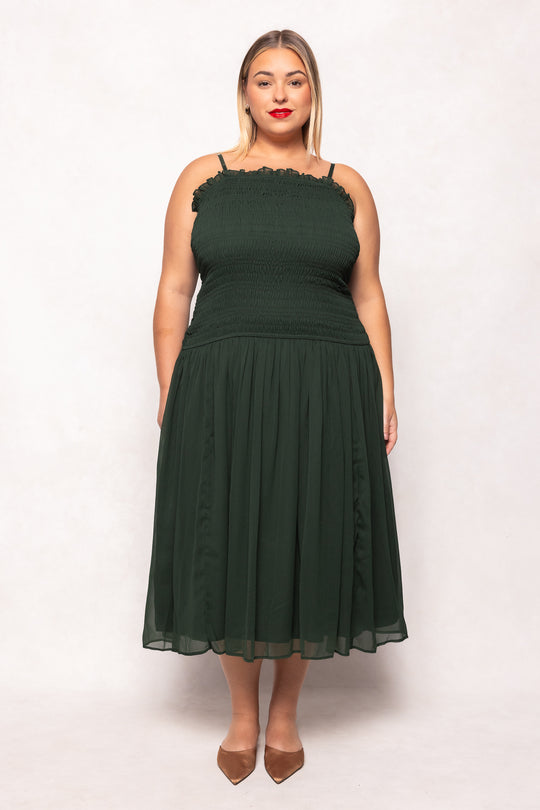 Woman wearing a green dress against a white background
