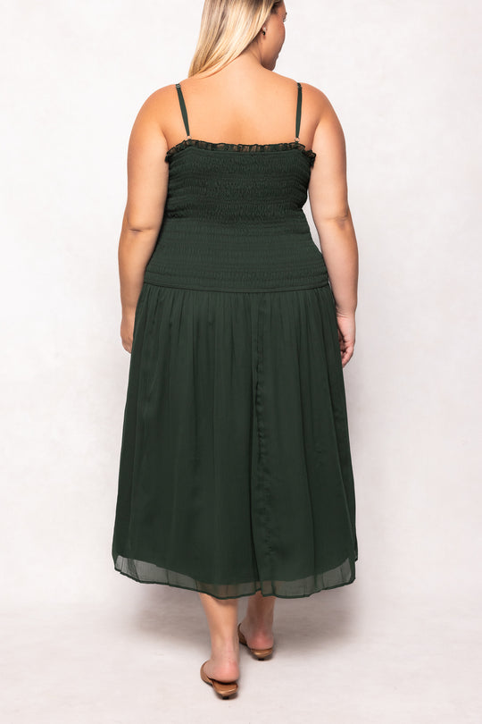 Woman wearing a green dress against a white background