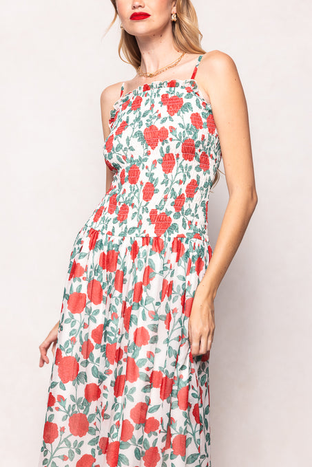 Woman wearing a floral dress with red flowers on a light background
